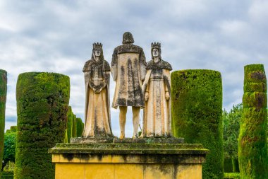 statue of Christian kings Ferdinand and Isabella with Christopher Columbus in the Alcazar, Cordoba, Spain