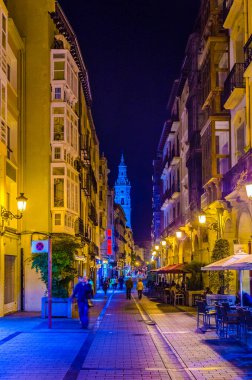 People are strolling a street in Logrono during nigh