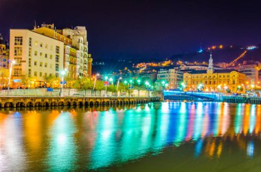 Bilbao, Spai 'deki belediye binasının yakınındaki Nervion nehrinin gece manzarası.