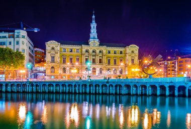 Night view of waterfront of Nervion river near the town hall in Bilbao, Spai