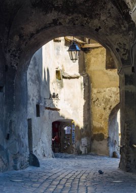 view of a medival gate situated inside of the citadel in romanian city sighisoara