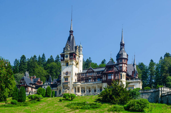 view of the famous peles castle situated on a hill above romanian city sinaia