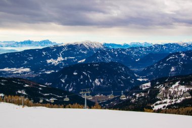 View of dolomites alps covered with snow from the gerlitzen mountain near villach.