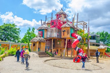 PRAGUE, CZECH REPUBLIC, APRIL 25, 2015: view of children playing on a giant plaground inside of the indonesian jungle pavillion in the zoo of prague