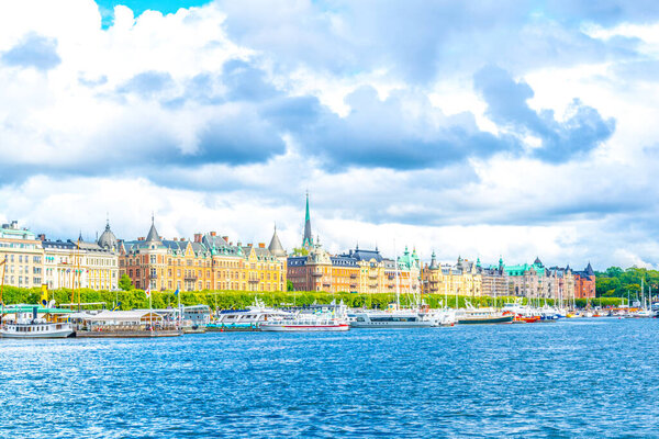View of Stockholm waterfront with beautiful old houses stretched alongside of it in Swede