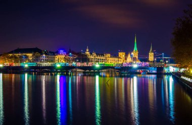 night view of illuminated skyline of the swiss city zurich taken from the promenade along the zurich lak