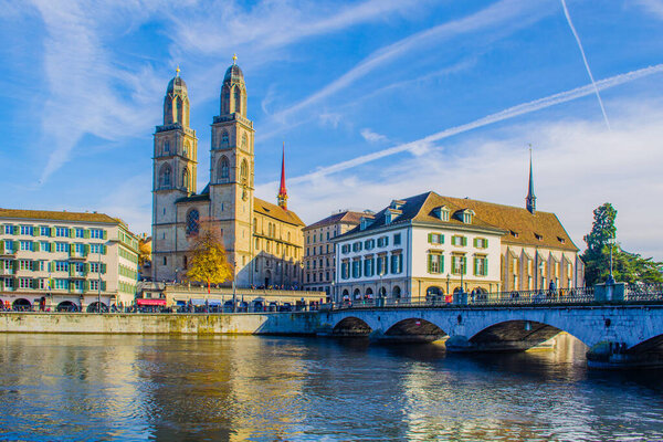 View of a quay of river limmat in the swiss city zurich which is dominated by the town hall on one side and grossmunster cathedral on the othe