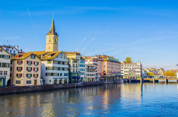 Panoramic view of historic Zurich city center on river Limmat on a sunny day with clouds in autumn, Canton of Zurich, Switzerlan