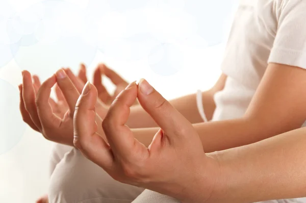 Woman sitting on the floor exercising yoga - detail of hand — Stock Photo, Image