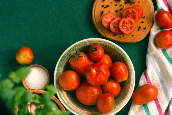 red tomatoes in a bowl on a dark background. selective focus.