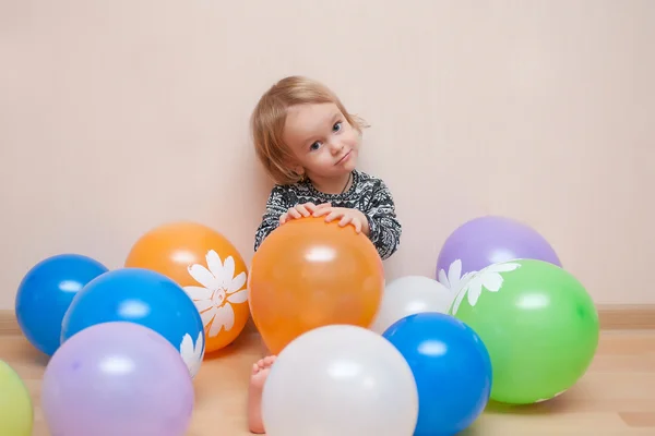 Baby girl and balloons — Stock Photo, Image