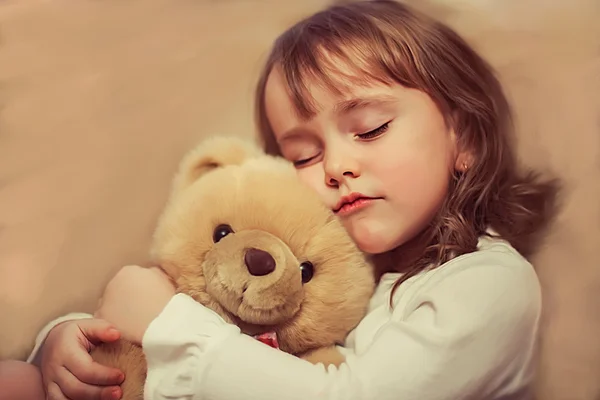 Lovely girl hugging her teddy bear — Stock Photo, Image