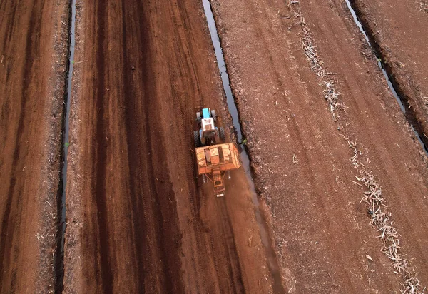 Peat Harvester Tractor on Collecting Extracting Peat. Mining and harvesting peatland. Area drained of the mire are used for peat extraction. Drainage and destruction of peat bogs.