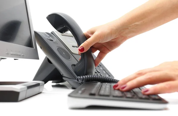 Woman is picking up the phone in support center — Stock Photo, Image