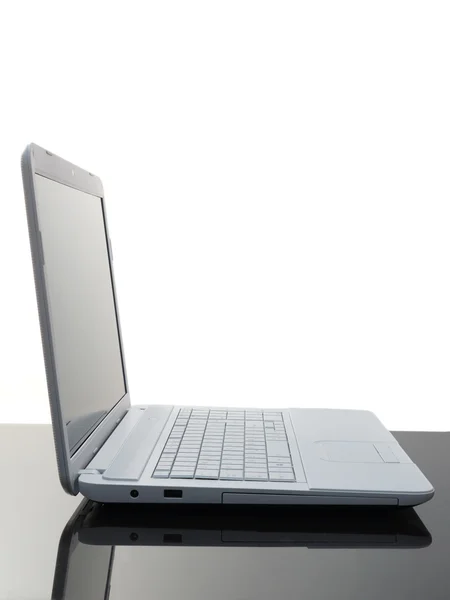 Laptop on black desk — Stock Photo, Image