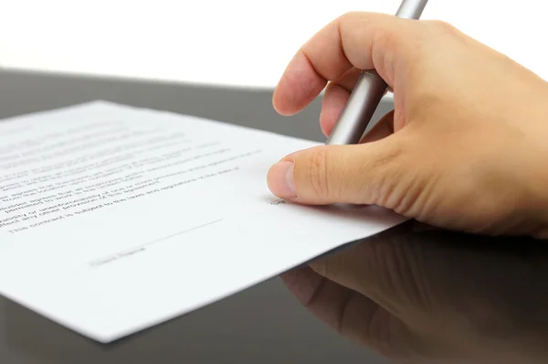 Businessman examines the articles of agreement before signing Stock Photo