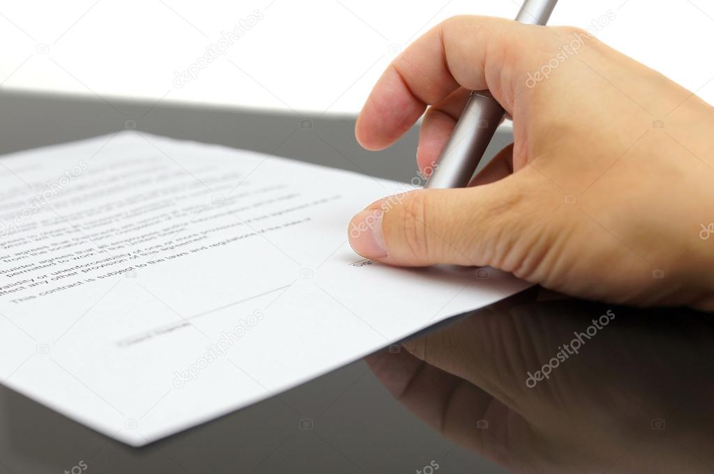 Businessman examines the articles of agreement before signing