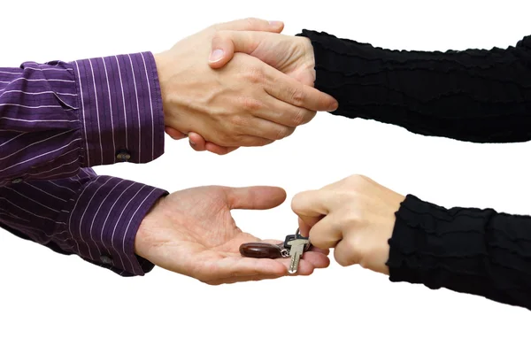Woman receiving a handshake and a house key at the same time — Stock Photo, Image