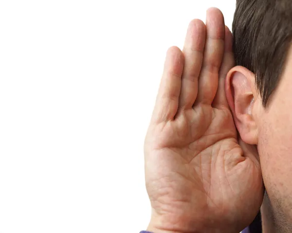 Businessman holds his hand near his ear and listening — Stock Photo, Image