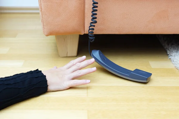 Woman try to reach the phone — Stock Photo, Image