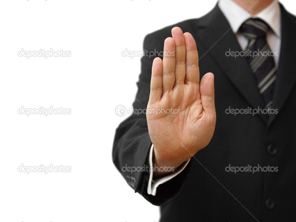 Businessman showing stop sign on neutral background