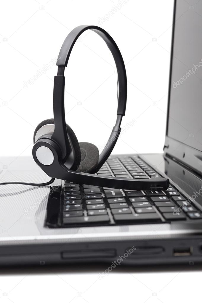 Laptop computer with headset on keyboard