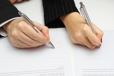 man and woman signing document or prenup clipart