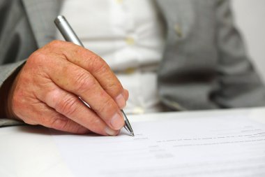 Older woman signing the document clipart