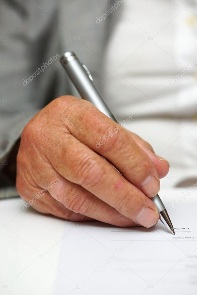 Older woman signing the document
