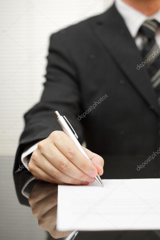 businessman is signing document