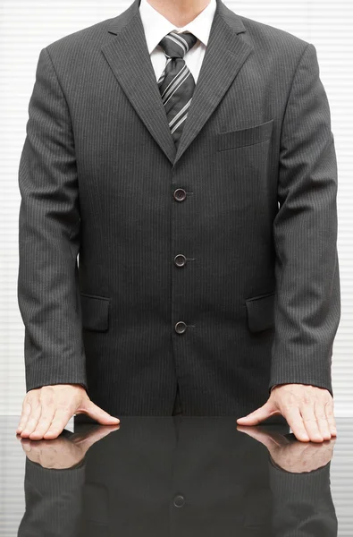 Closeup  of a well dressed businessman with hands on the desk at — Stock Photo, Image