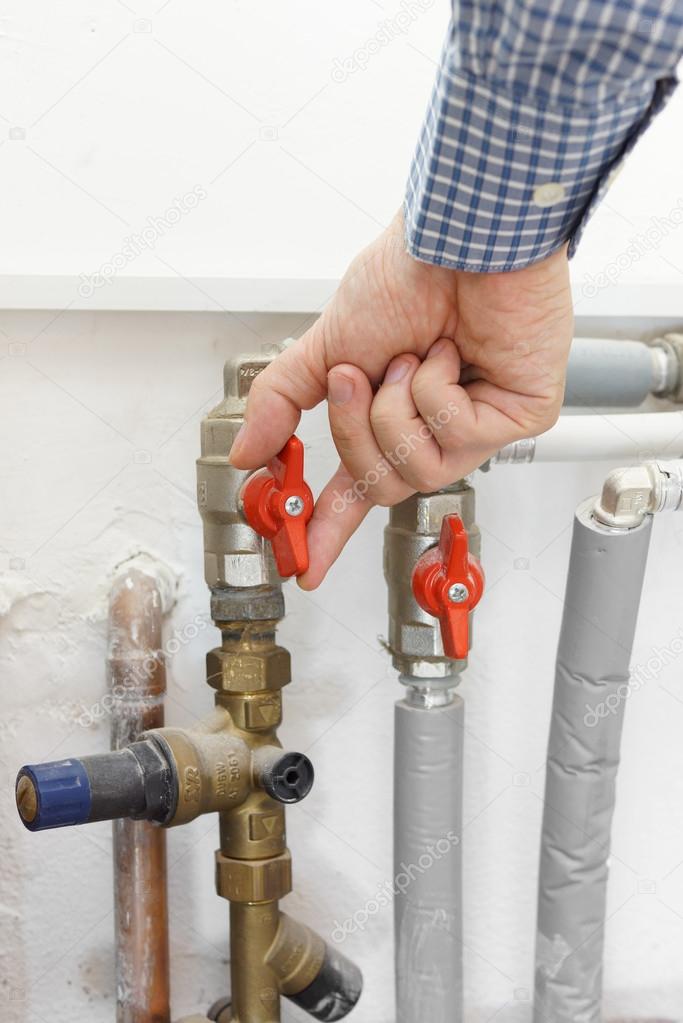 Plumber opens the valve