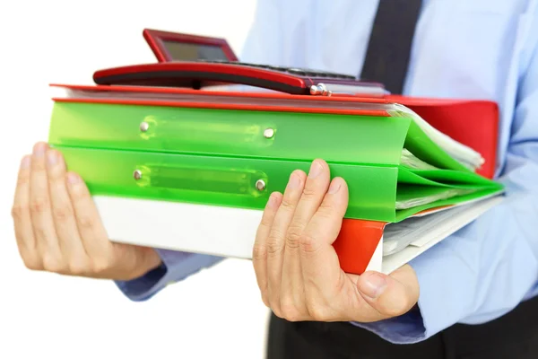 Businessman carrying binders with documents and calculator — Stock Photo, Image