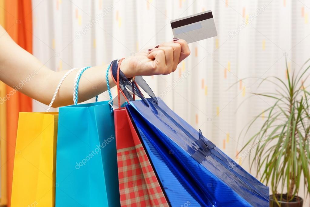 Woman with  shopping bags bought with a debit or credit card at 