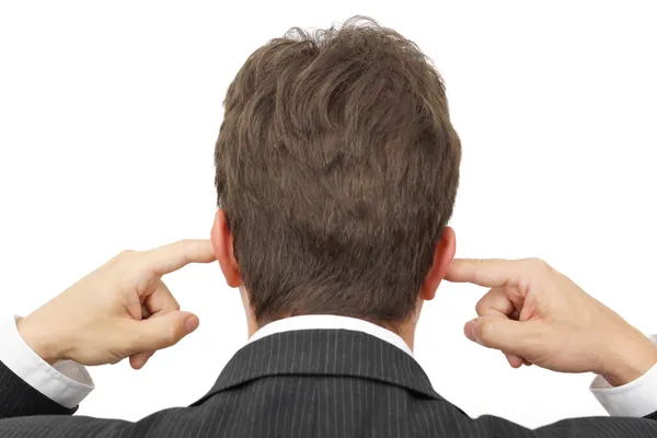 Empresário bloqueando seus ouvidos com os dedos  . Fotografia De Stock