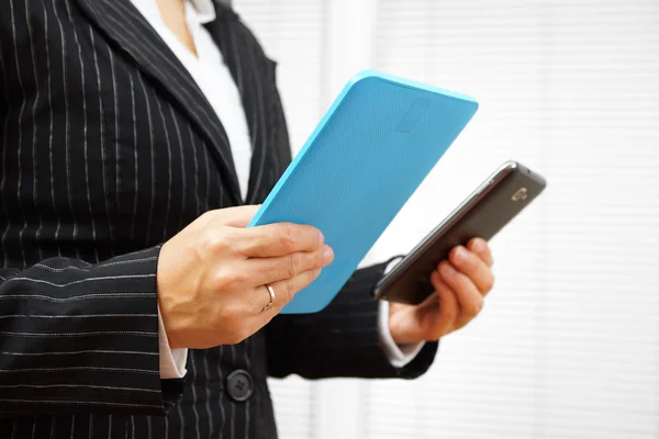 Busy businesswoman using digital tablet and mobile phone at he s — Stock Photo, Image