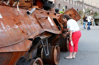 A woman examines destroyed Russian army equipment displayed on Khreshchatyk in downtown Kyiv. On August 24, 2022, Ukrainians will celebrate the 31st anniversary of Independence Day. On February 24, 2022, Russia invaded Ukraine, triggering the largest
