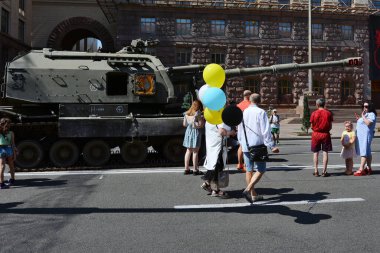 KYIV, UKRAINE - August  21, 2022: People inspect the destroyed Russian army equipment displayed at Khreshchatyk in the center of Kyiv.