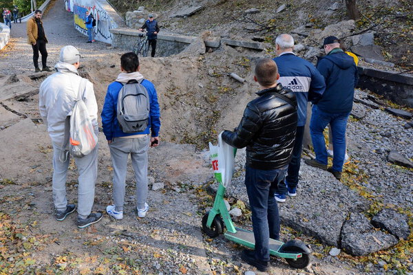 A huge hole was formed near a pedestrian bridge after Russian missiles hit the capital of Ukraine, Kyiv, on October 10, 2022.