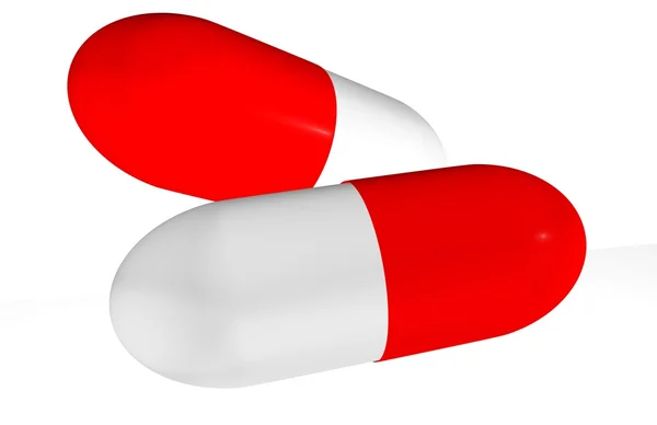 Дві червоні таблетки ізольовані на білому — стокове фото