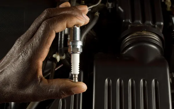 Mechanic and spark plug — Stock Photo, Image