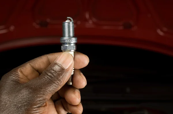 Mechanic and spark plug — Stock Photo, Image