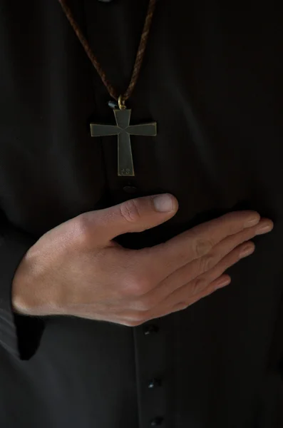 Hands below crucifix — Stock Photo, Image