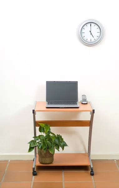 Office desk, laptop and clock — Stock Photo, Image