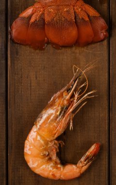 Crayfish tail and prawn on table clipart