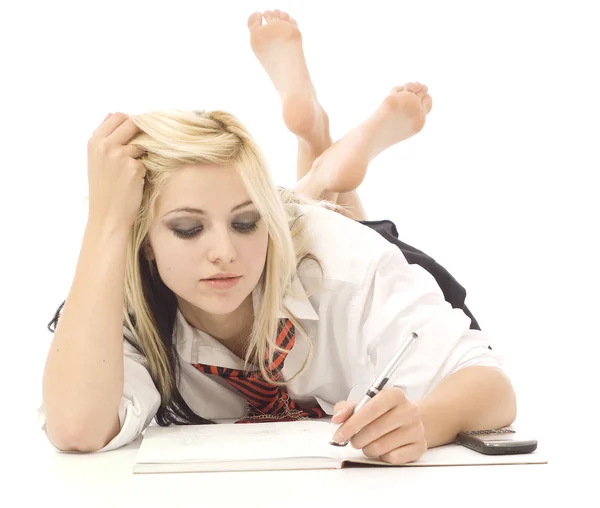 Pretty teenage girl doing homework — Stock Photo, Image