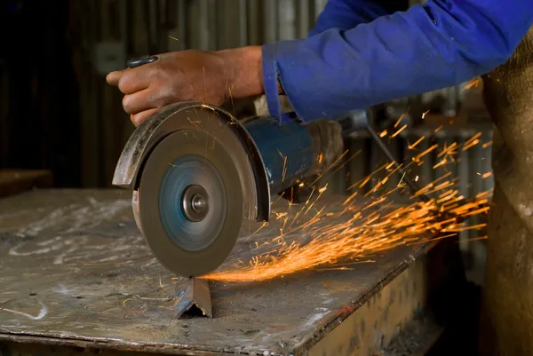 African American with angle grinder — Stock Photo, Image