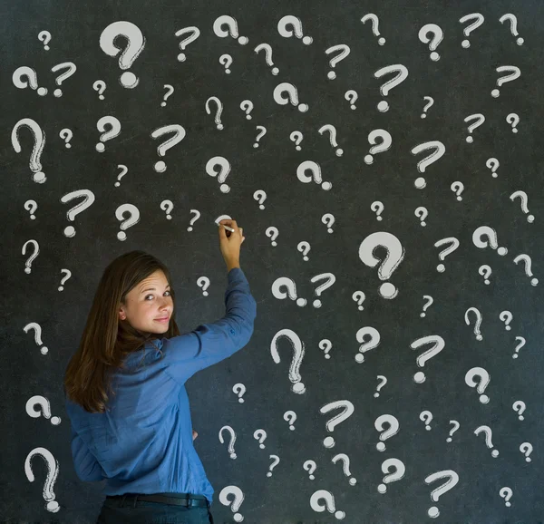 Thinking business woman with chalk question marks — Stock Photo, Image