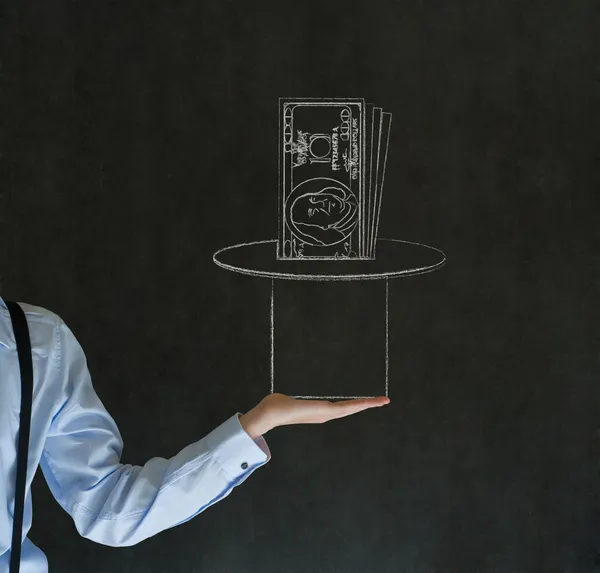 Man pulling money from magic hat blackboard background — Stock Photo, Image