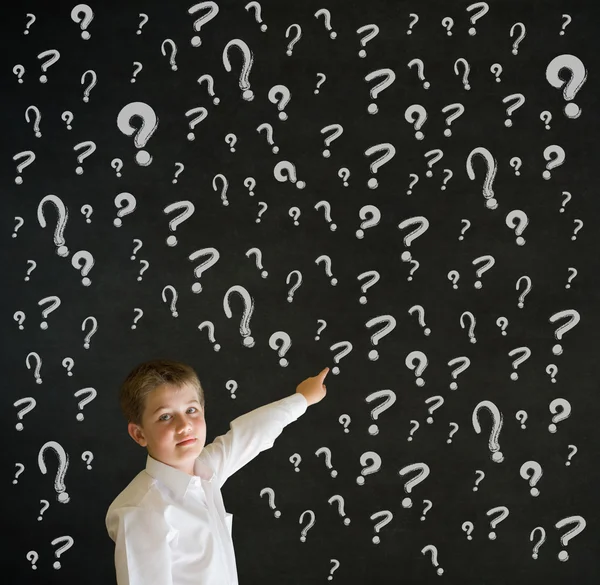 Pointing boy dressed as business man with chalk question marks — Stock Photo, Image